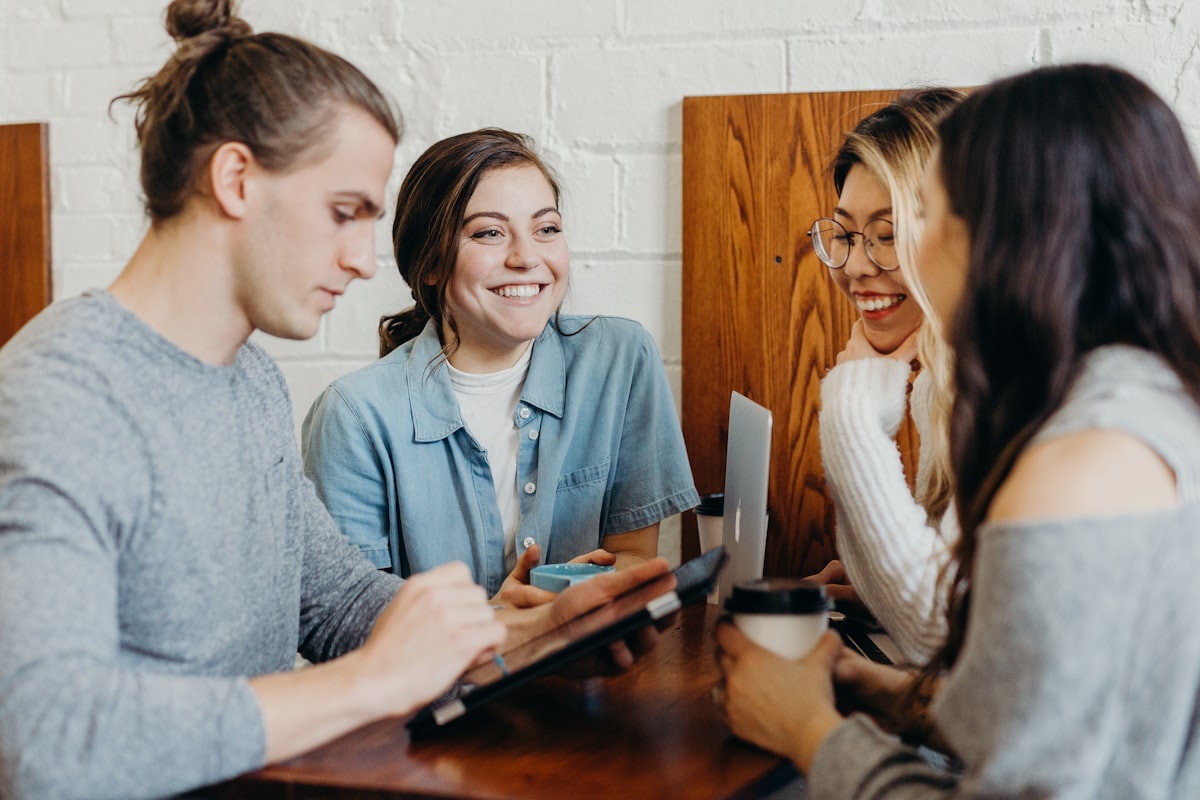 Financial mentor speaking with clients around a table